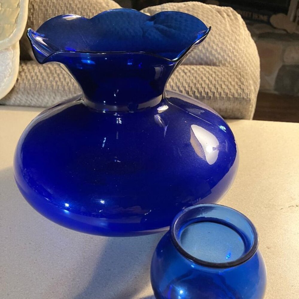 Two Blue Cobalt Glass Vases, One Wavy Rim, One Plain, Both Rest On Pedestals